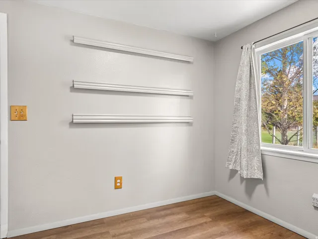 Wood-finish flooring with light-toned walls and trim