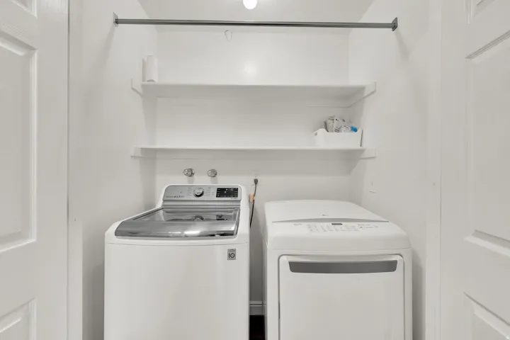 Utility closet with built-in shelving, a clothes rod, and white panel doors