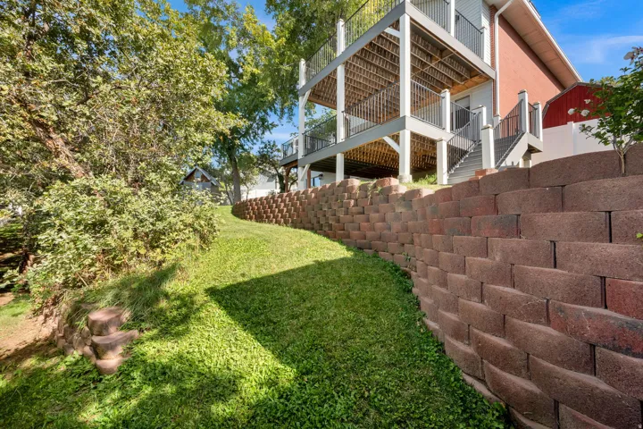 Two-story deck with dark railings, accessed by exterior stairs