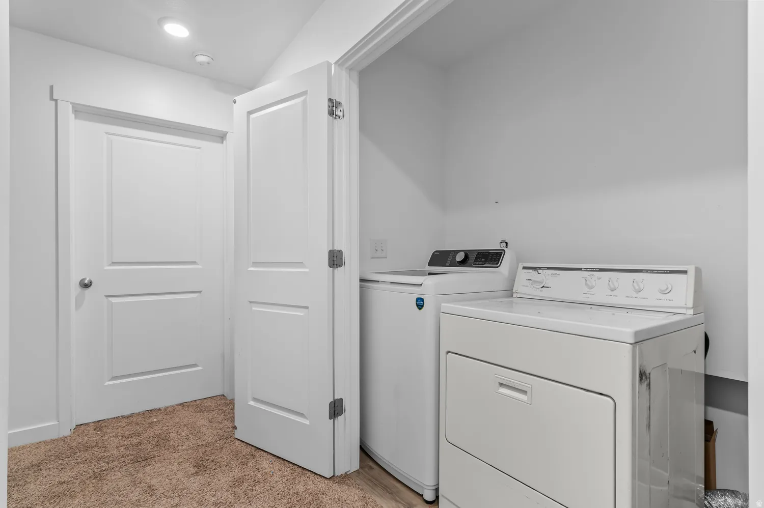White interior doors, recessed lighting, and a neutral wall color