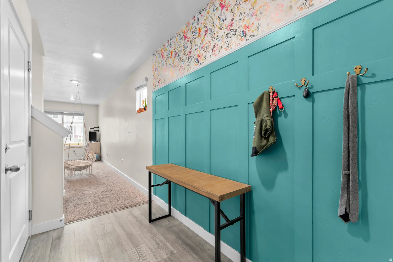 Board and batten accent wall, wood-finish flooring, recessed lighting, and a white interior door