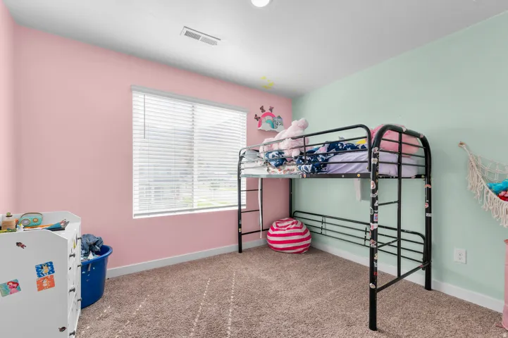 Recessed ceiling lighting, a large window with blinds, and wall-to-wall carpeting