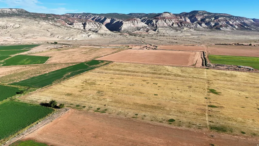 Expansive open land featuring varied terrain and distant mountains