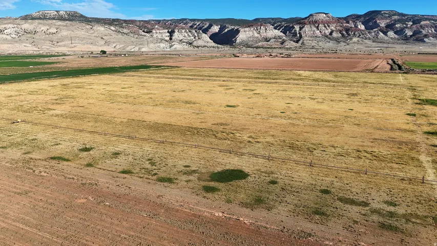 Expansive rural acreage featuring varied terrain and distant mountain backdrop