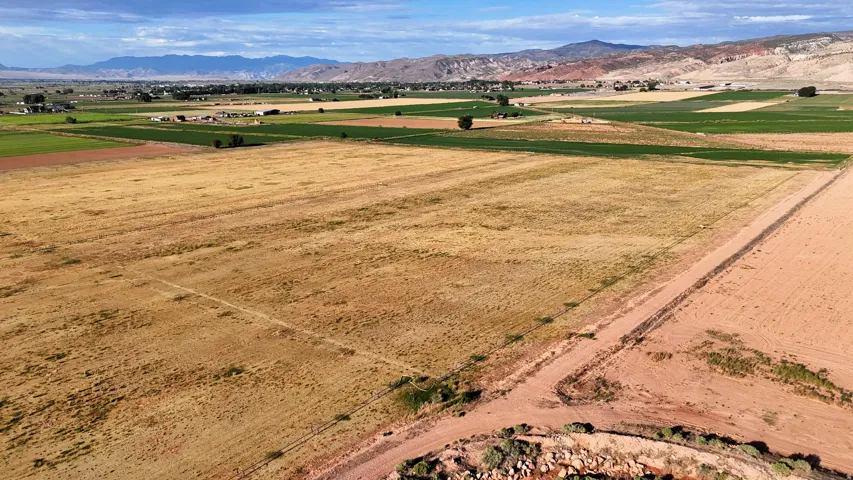 Expansive open land with varied terrain and distant mountain ranges