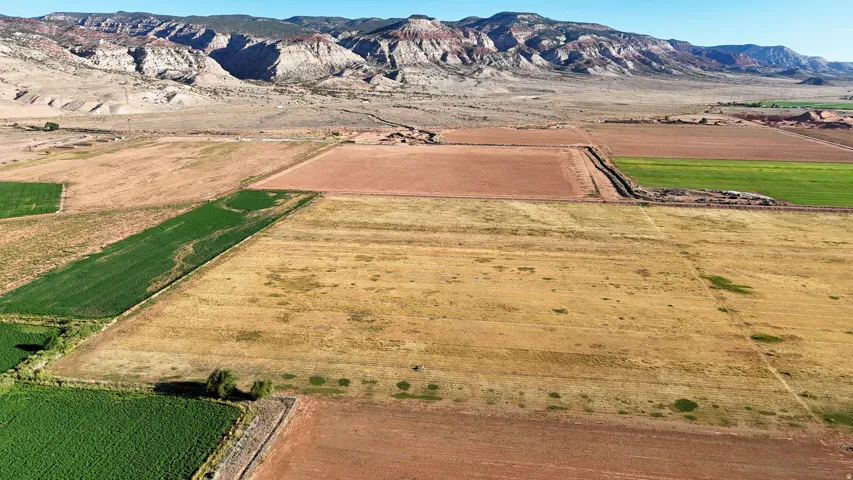 Expansive agricultural land featuring a variety of cultivated fields and natural terrain