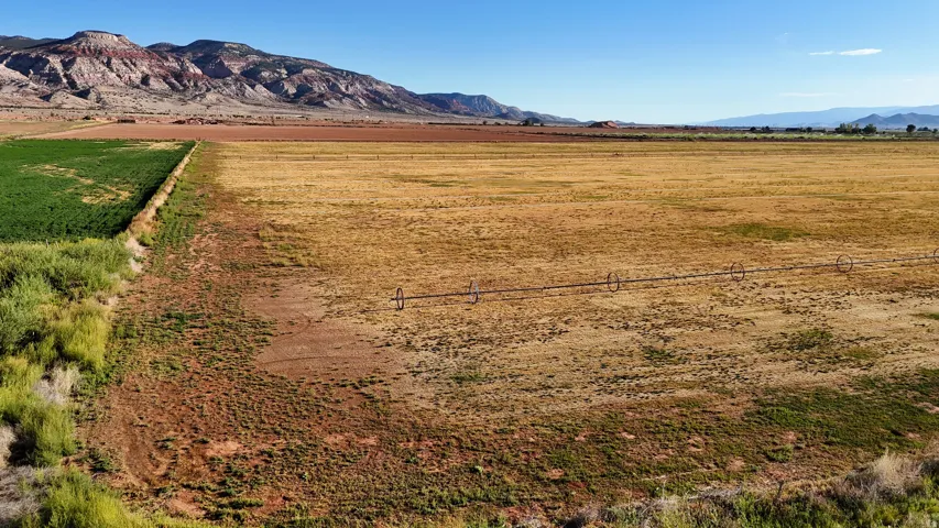 Expansive open land with distant mountains and clear skies
