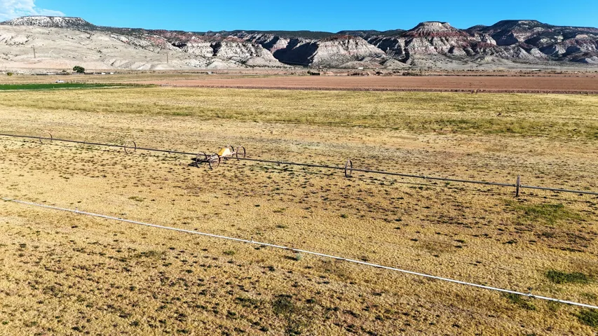 Expansive acreage featuring an irrigation system and a mountainous backdrop