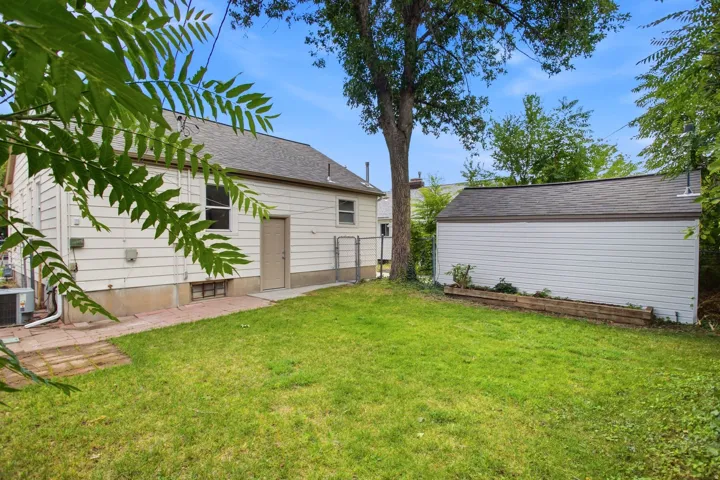 Expansive green lawn with a detached auxiliary structure