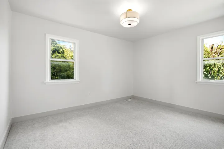 Light gray carpeting and white painted walls