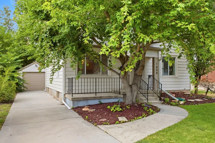 White siding exterior with a concrete driveway and an attached garage