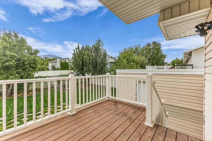 Spacious outdoor deck with wood-finish flooring and white railings