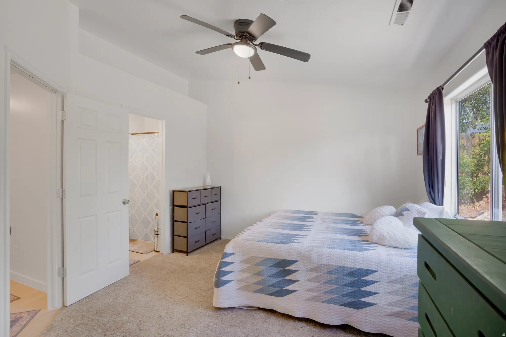 Carpeted flooring, ceiling fan with light fixture, window with trim, and white paneled doors