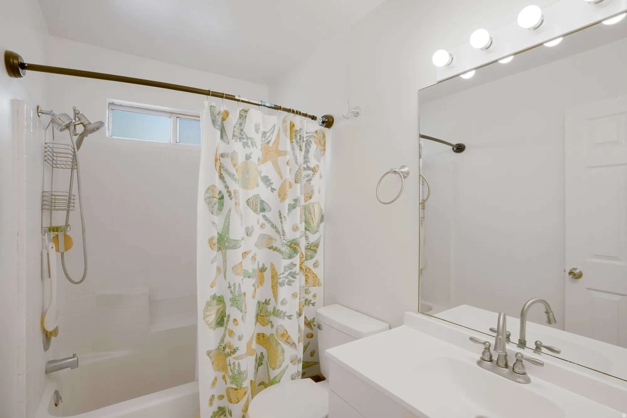 White vanity with an integrated sink and brushed nickel faucet