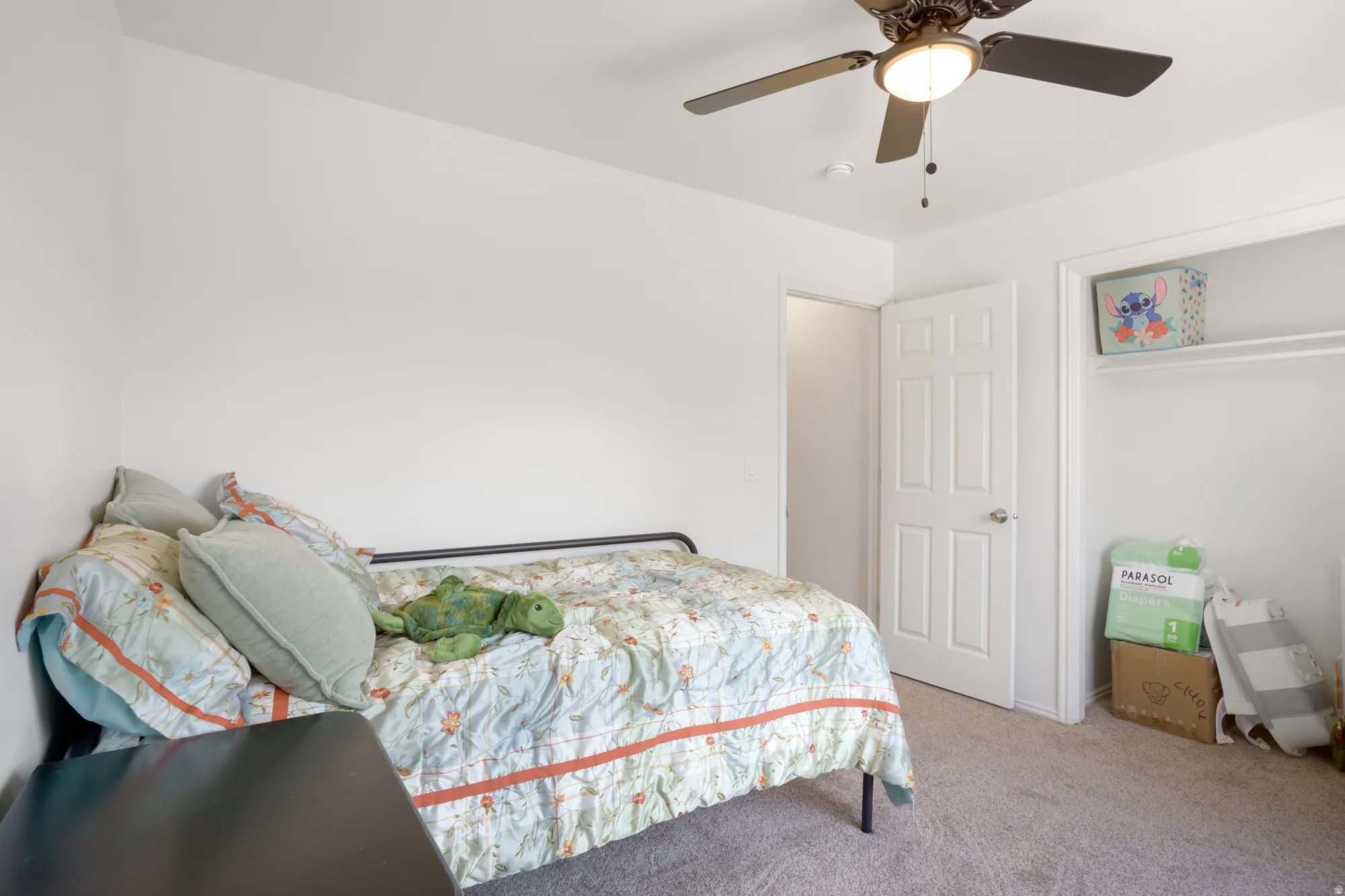 Recessed ceiling fan with integrated lighting, paneled interior doors, and an open closet with shelving