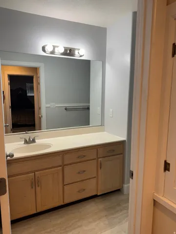 Vanity with light-toned cabinetry, a built-in sink, and a light-colored countertop