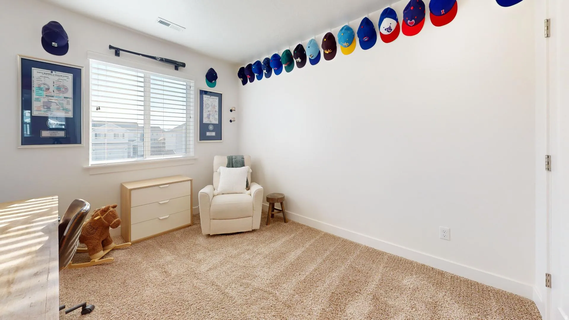 Neutral wall color with large window featuring horizontal blinds