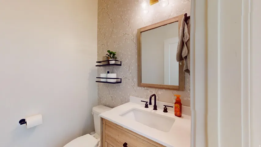Vanity with white countertop, undermount sink, and matte black faucet