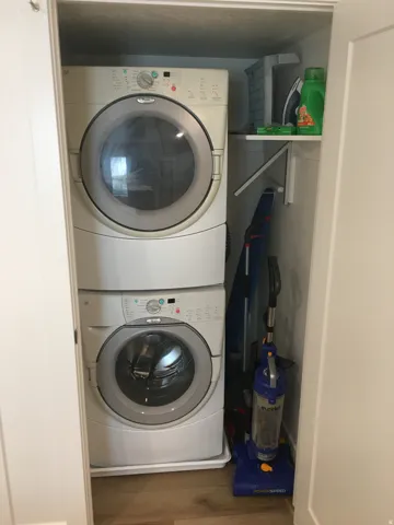 Stacked laundry appliances within a dedicated closet