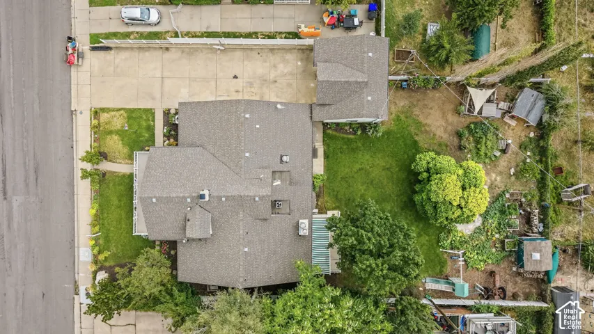Expansive lot featuring a main residence with a gabled roof and a separate 2-car Garage.