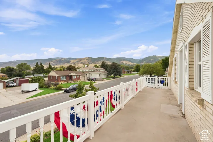 Balcony with white railing and mountain backdrop