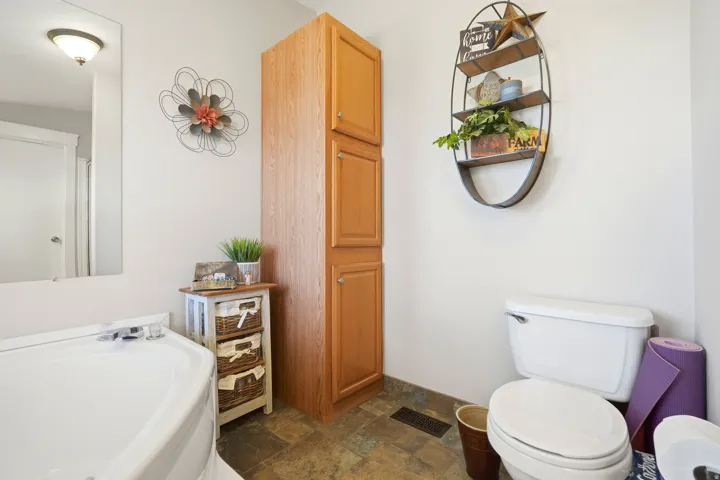 Recessed lighting, wood-finish flooring, full-height cabinetry, and a built-in wall shelf
