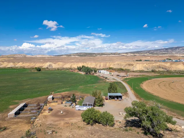 Extensive property with a main residence, multiple outbuildings, and agricultural fields