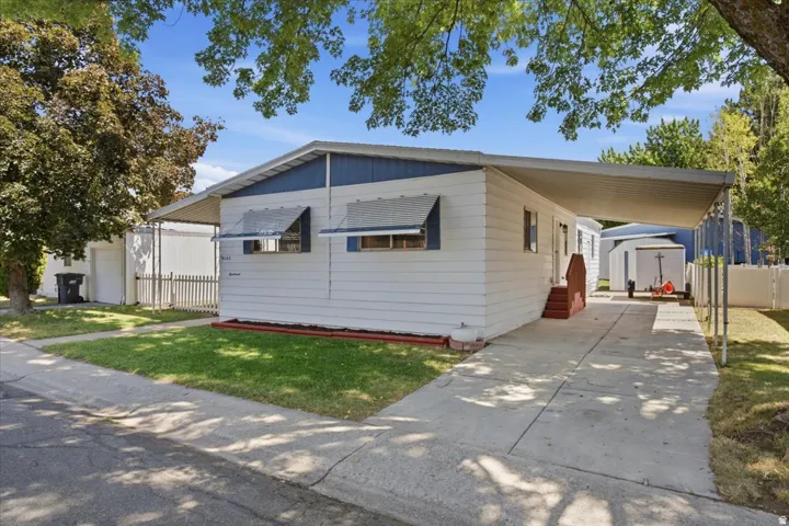 White siding exterior with blue trim accents