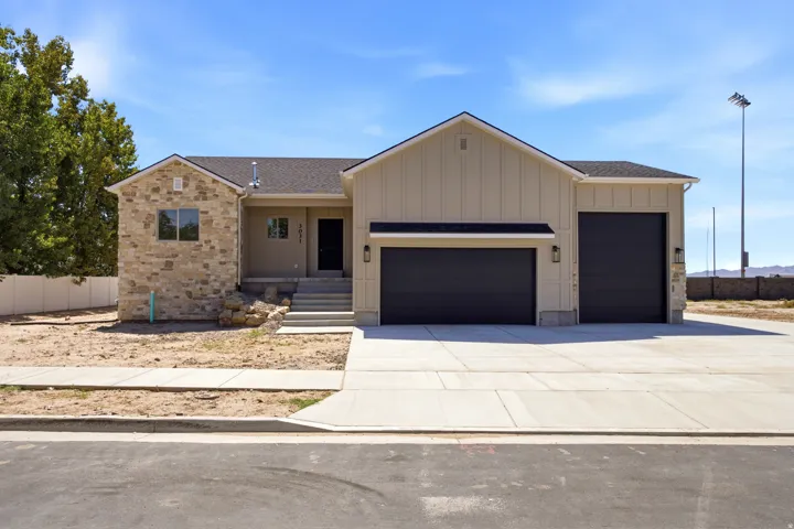 Stone veneer and board and batten exterior with a dark asphalt shingle roof