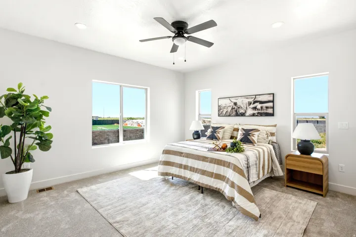 Recessed lighting, ceiling fan, multiple windows, and carpeted flooring