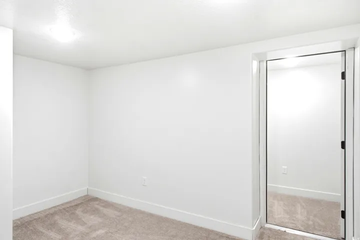 Wall-to-wall carpeting, recessed lighting, white walls, and white trim