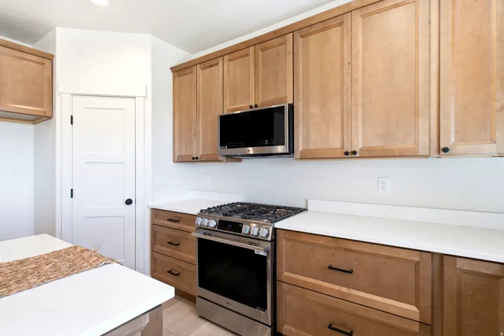 Wood-finish cabinetry with matte black hardware
