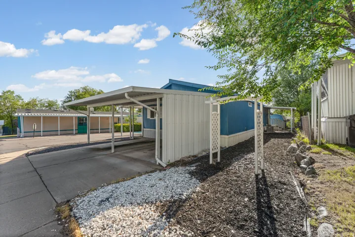 Attached carport with a concrete driveway