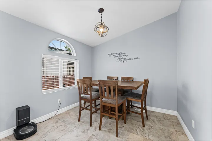 Arched transom window over a rectangular window, light gray walls, and light-colored tile flooring
