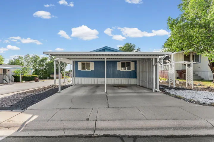 Carport with concrete driveway and gravel landscaping