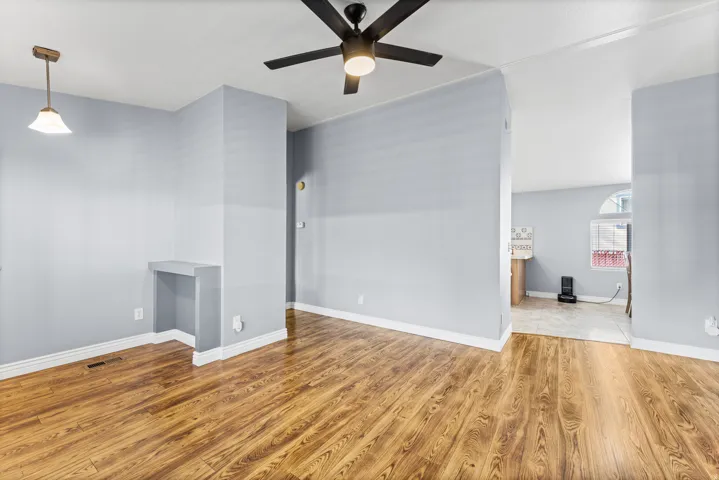 Spacious open floor plan with gleaming wood-finish flooring throughout