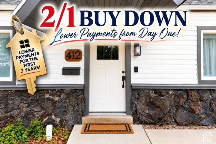 Exterior facade featuring horizontal white siding, stone veneer base, white entry door with a multi-pane glass insert, dark metal mailbox, and rectangular exterior wall-mounted lighting