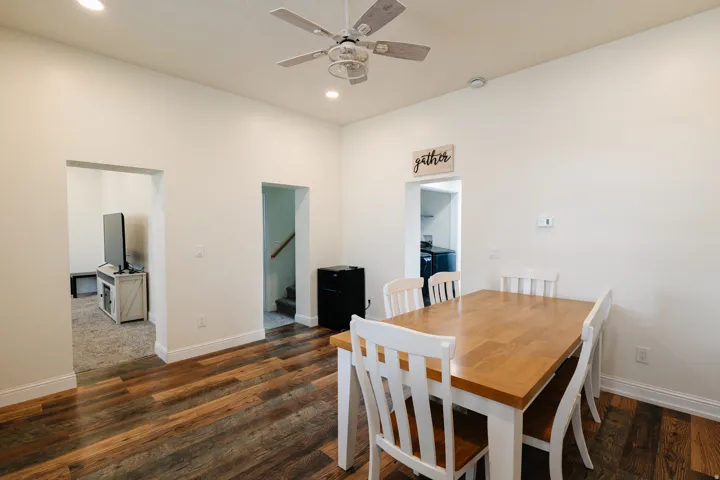 Wood-finish flooring throughout, recessed ceiling lighting, and a ceiling fan with light fixture