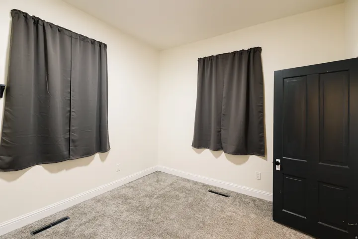 Neutral wall finishes and gray carpeting with white trim