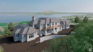 Multi-level residence featuring a stone and siding exterior, multiple gabled roofs, a prominent front portico, and expansive windows