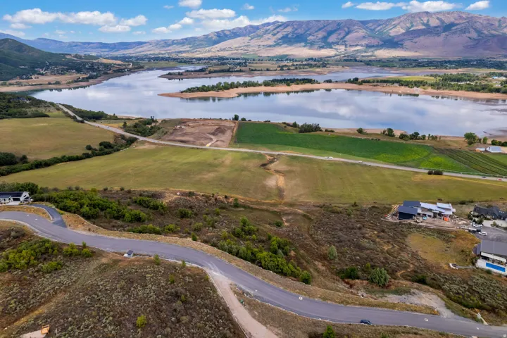 Expansive natural landscape featuring a prominent lake and distant mountains