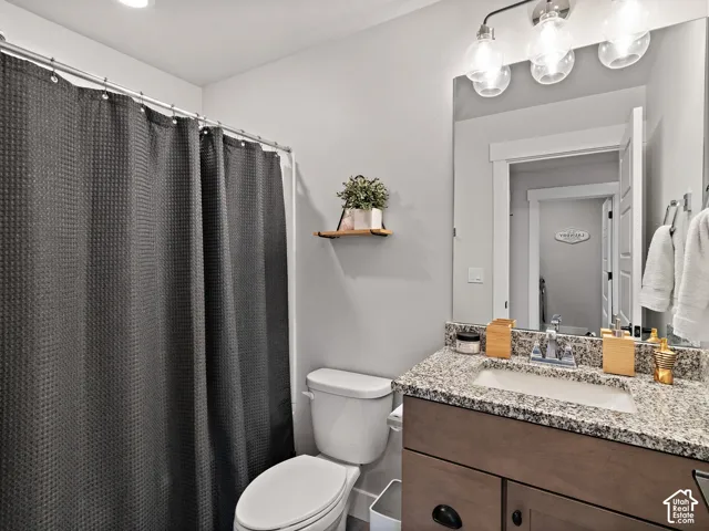 Vanity with a granite countertop and an integrated sink