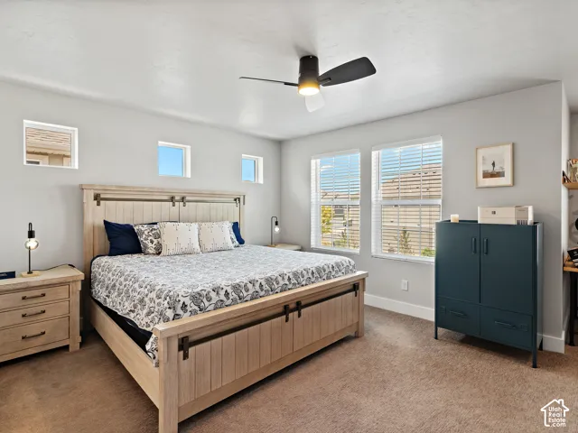 Recessed lighting, ceiling fan with light fixture, carpeted flooring, and multiple windows with blinds