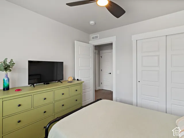White walls and trim throughout, with a ceiling fan featuring an integrated light fixture
