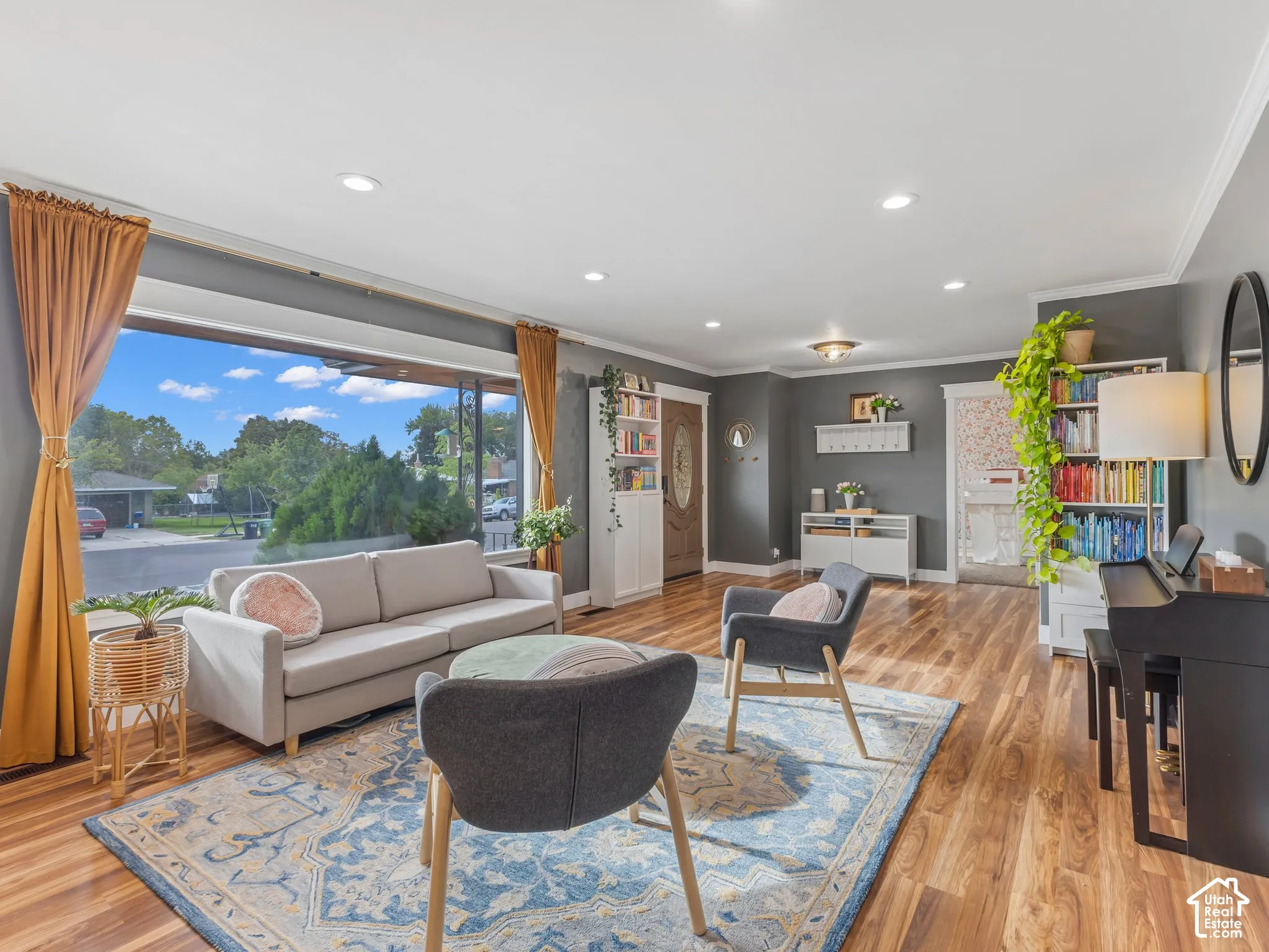 LVP flooring throughout, expansive window, built-in shelving, recessed ceiling lighting, and crown molding
