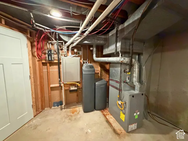 Utility room with water heater, water softener, and forced air unit