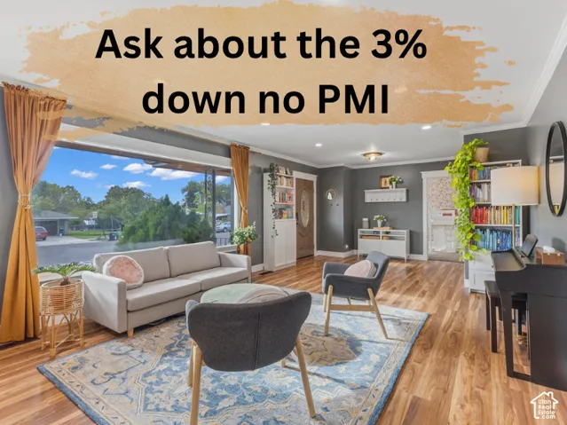 Living area featuring large-pane picture windows, wood-finish flooring, built-in floor-to-ceiling shelving, recessed ceiling lighting, and crown molding