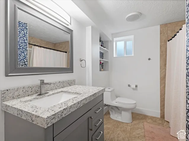Vanity with a light-toned countertop, integrated sink, and brushed nickel faucet