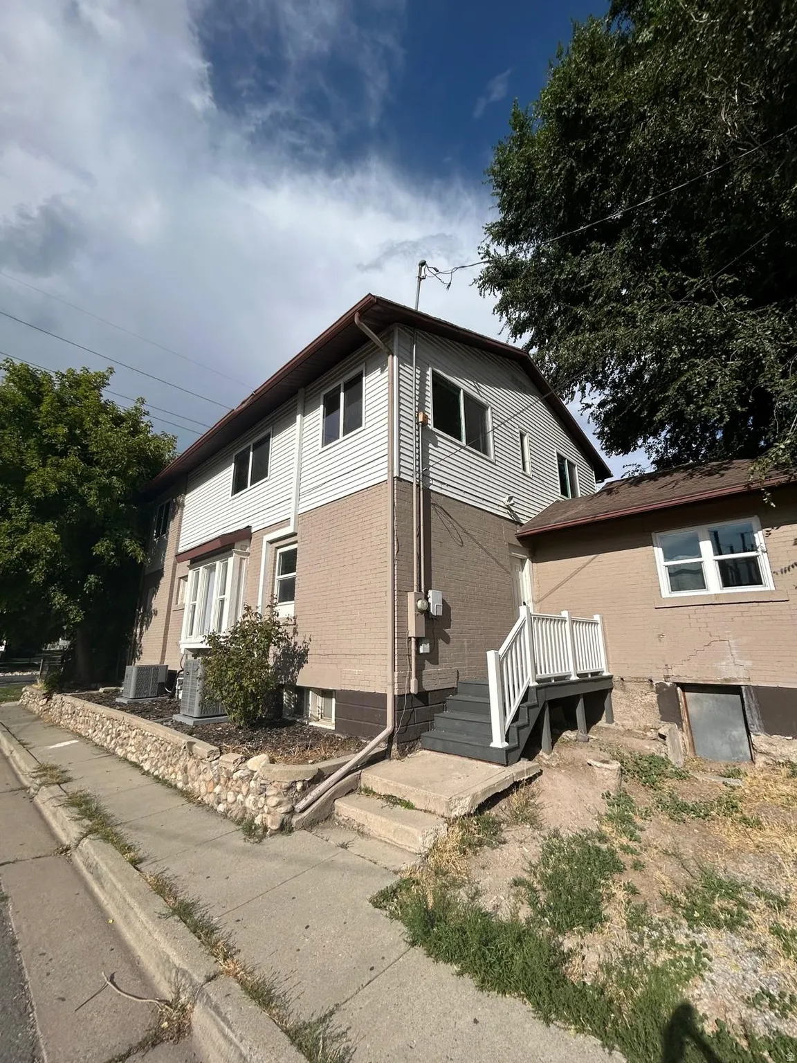 Two-story exterior with horizontal siding and brick cladding