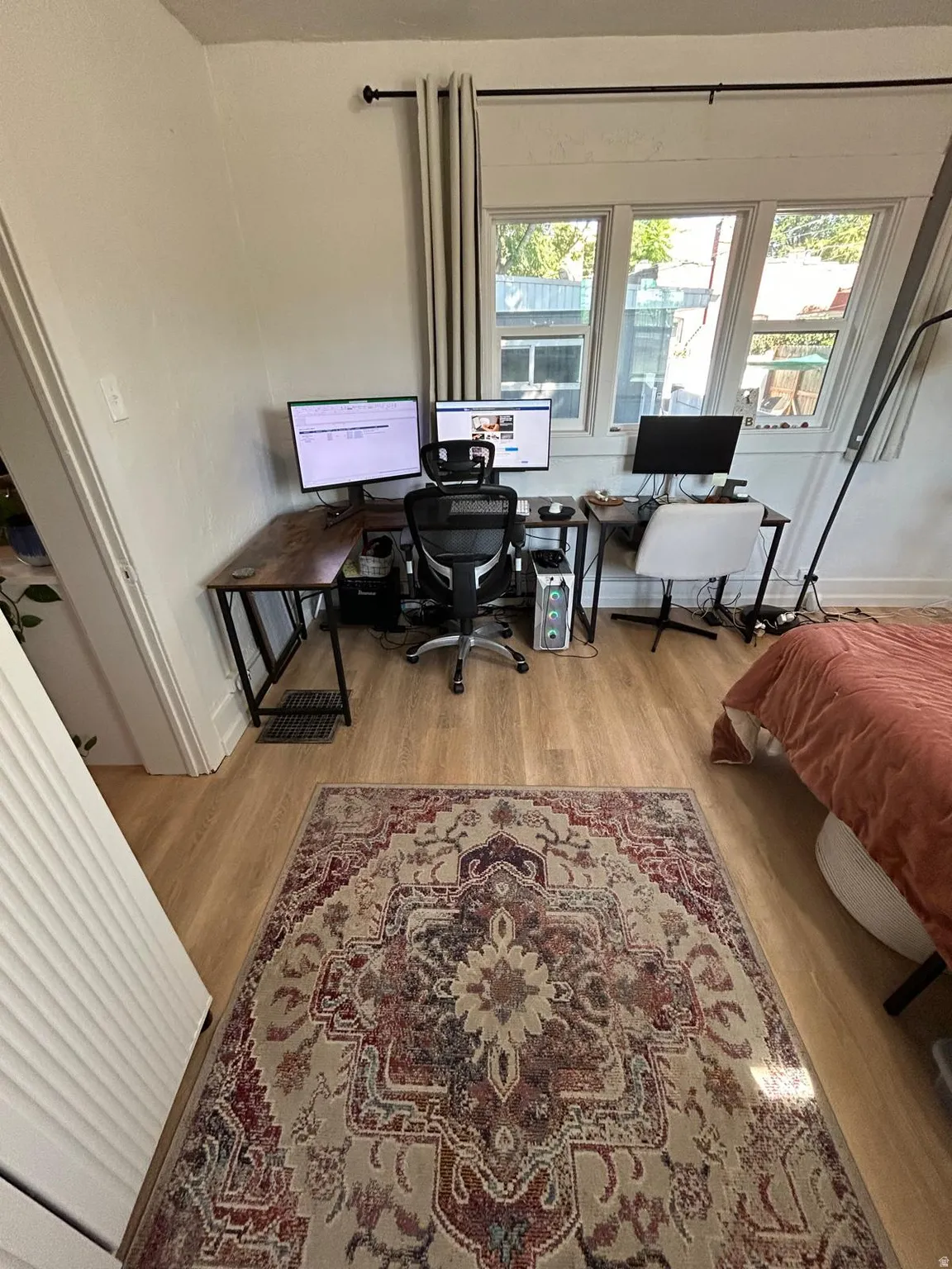 Wood-finish flooring throughout, featuring a large window with multiple panes